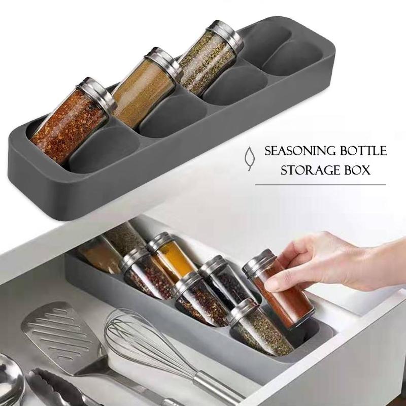 The Spice Rack Organizer stored in a draw filled with herb and spice bottles being easily accessed by its owner