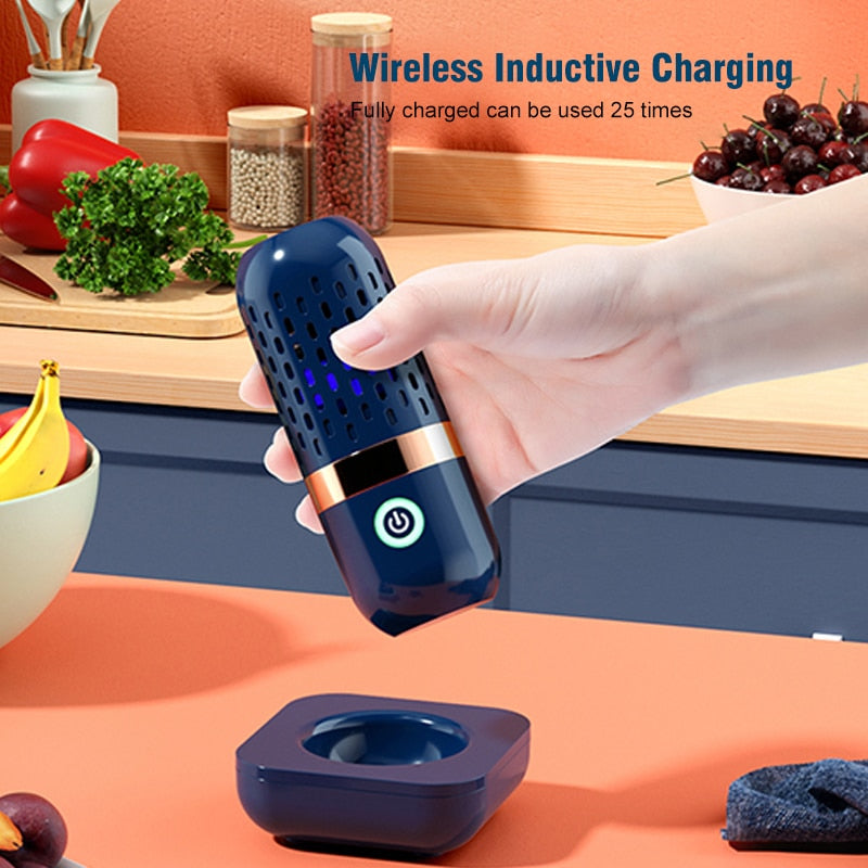 Portable Ultrasonic Fruit Cleaner being held in a kitchen next to its charging unit. Wireless inductive charging, can be used 25 times from a fully charged state.