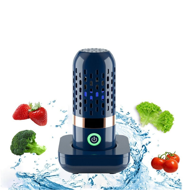 Portable Ultrasonic Fruit Cleaner and its charging unit surrounded by water, fruit and vegetables.