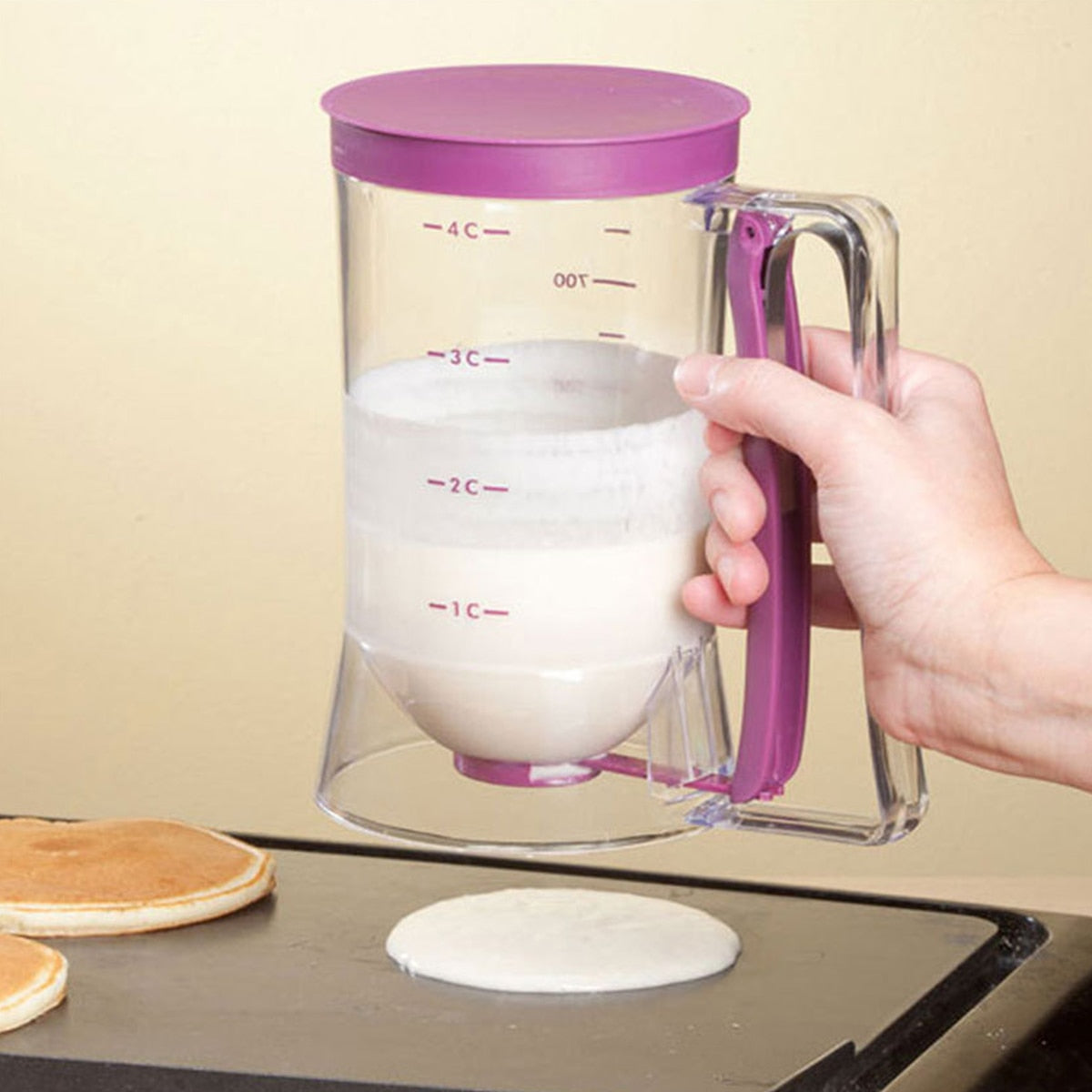 Pancake Batter Dispenser dispensing pancake mix onto a grill