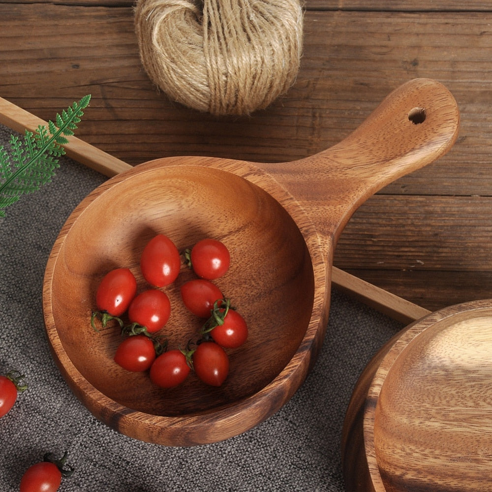 Wooden Sauce Dish With Handle on a bench-top containing some cherry tomatoes